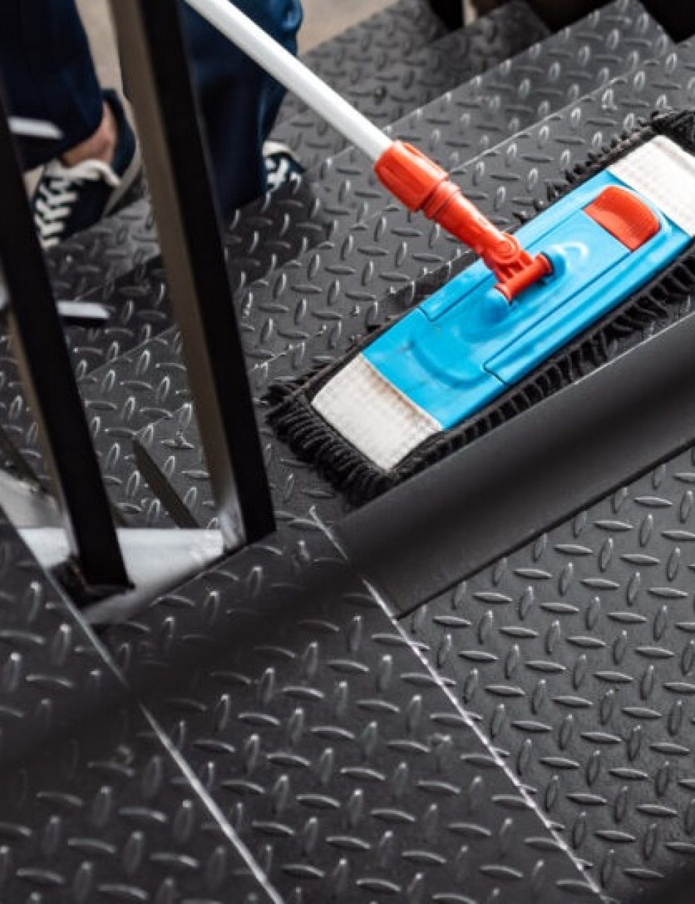 cropped view of cleaner washing stairs with mop
